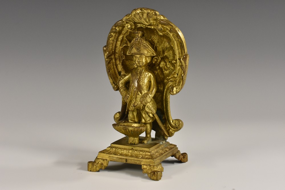A 19th century gilt bronze novelty, of a Manneken Pis, he stands, in military dress,