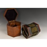 A 19th century concertina, by Lachenal & Co, London, thirty two keys, pierced hexagonal ends,