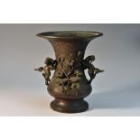 A Chinese dark patinated bronze vase, cast with temple lions and blossoming prunus,