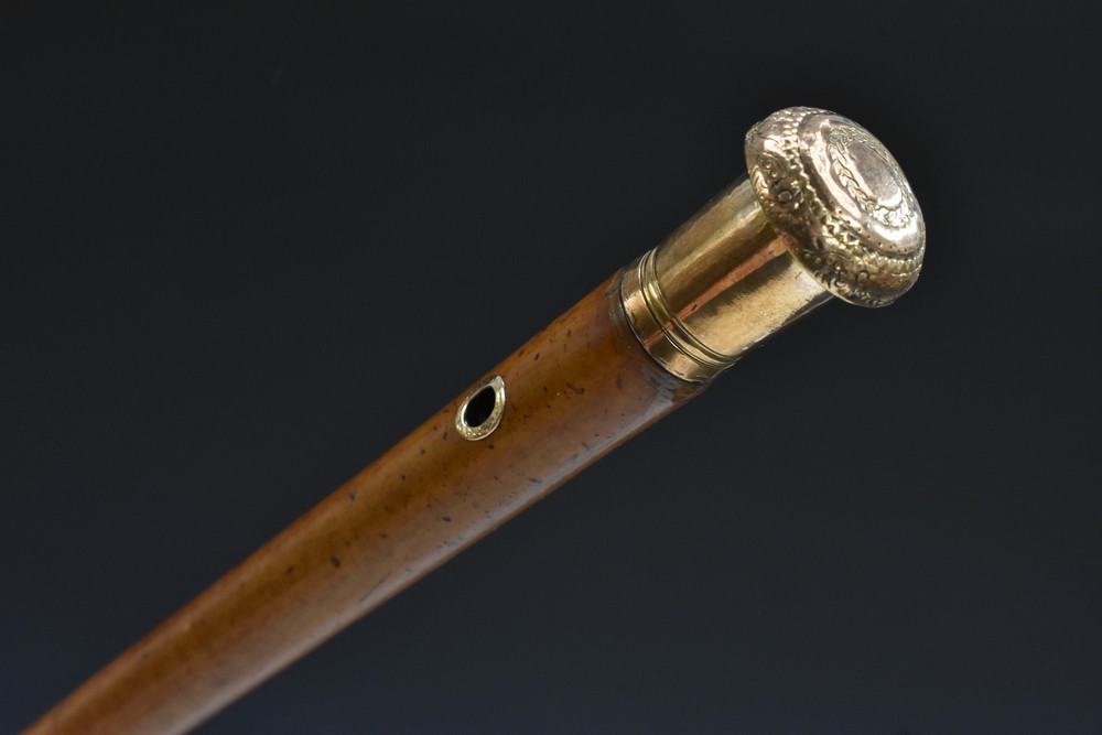A 19th century gold coloured metal mounted malacca gentleman's walking cane,