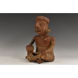 Antiquities - a terracotta pre-Columbian figure, seated cross-legged, holding a vessel,