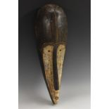 Tribal Art - a Fang Ngil mask, typically concave with elongated features,