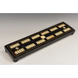 A 19th century Colonial ebonised and ivory cribbage board,