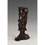 A Chinese hardwood carving, of the smiling Budai, he stands hupon his cloth sack,