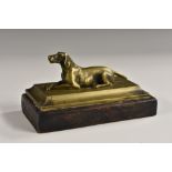 A 19th century bronze desk weight, cast as a recumbent hound, rectangular base, 14.