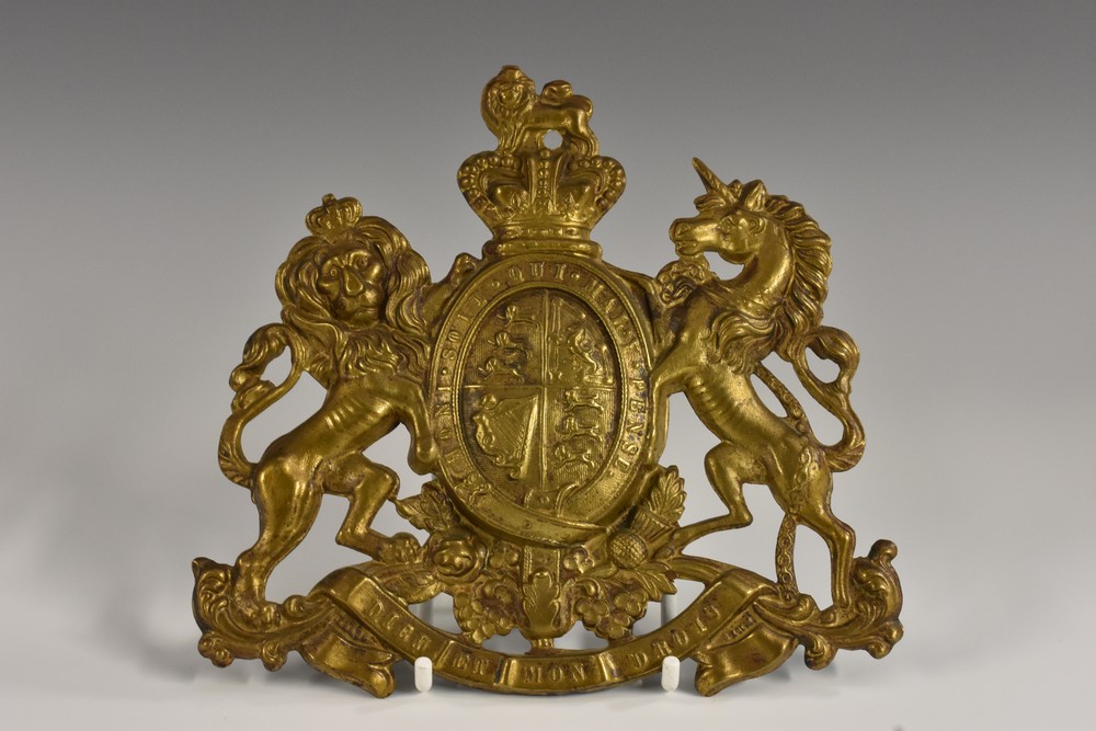 A 19th century gilt metal plaque, embossed with the Royal Coat of Arms, 15.