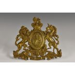 A 19th century gilt metal plaque, embossed with the Royal Coat of Arms, 15.