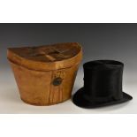 A gentleman's black silk top hat, by J Wippell and Co Ltd, Exeter, tan leather case, 35cm wide,