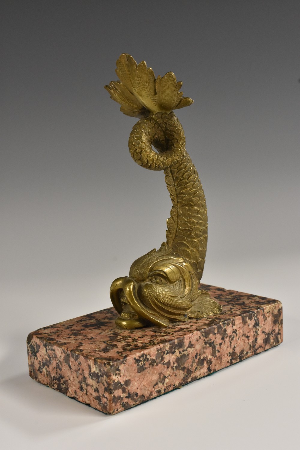 A 19th century gilt desk bronze, of a dolphin, rectangular granite base,