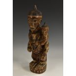Tribal Art - an African fertility figure, she stands, holding an infant,