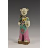 A Chinese high-fired stoneware figure, decorated in polychrome, 21cm high,