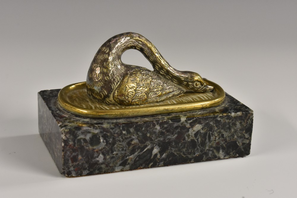 A 19th century gilt and silvered desk weight, cast as a swan, with neck curled,