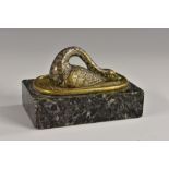 A 19th century gilt and silvered desk weight, cast as a swan, with neck curled,