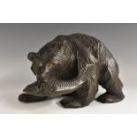 A Black Forest type carving, of a bear holding a salmon.