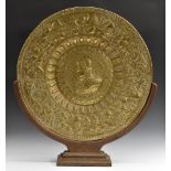 A substantial Renaissance Revival brass charger, embossed with a portrait of Margaret of Austria,