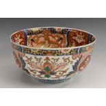 A Japanese Imari porcelain circular flared bowl, boldly decorated in the typical palette, gilt rim,