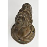 A Renaissance style bronze architectural boss, cast as the head of a grotesque Venetian, 12cm high,