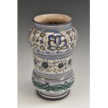 A South European maiolica albarello drug jar, painted in polychrome with bands of stylised flowers,