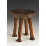 Tribal Art - a Kamba stool, dished circular top, slightly outswept legs, pad feet, 30.
