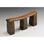 Tribal Art - a Zulu headrest, gently bowed plateau, three block feet carved with geometric motifs,