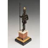 Continental School (19th century), a parcel-gilt and dark patinated bronze, of an Imperial Soldier,