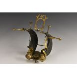 An Indian brass mounted ram's horn desk stand, crested by a photograph frame, 35cm wide, c.