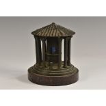 A Grand Tour bronze inkwell, as a rotunda, marble base,