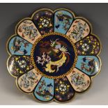 A Japanese cloisonne enamel shaped circular charger, brightly decorated with dragons and phoenix,