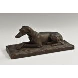 A 19th century Continental painted terracotta canine model, of a recumbent greyhound,
