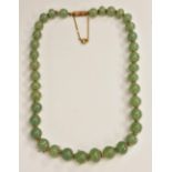 A string of Chinese pale green jade beads,