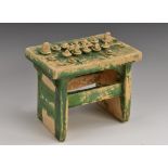 A Chinese earthenware tomb model, as a table laden with funerary offerings,