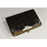 An Edwardian silver mounted 'crocodile' leather wallet, the kid lined interior with compartments,