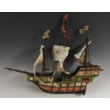 An early 20th century scratch built model of a galleon, wooden hull, canvas sails,