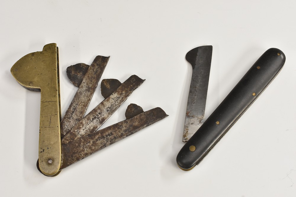 A 19th century brass blood-letting fleam, three steel blades, 9cm long (folded); another,