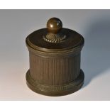 A Regency brown patinated bronze cylindrical inkstand, the stepped cover with globular finial,