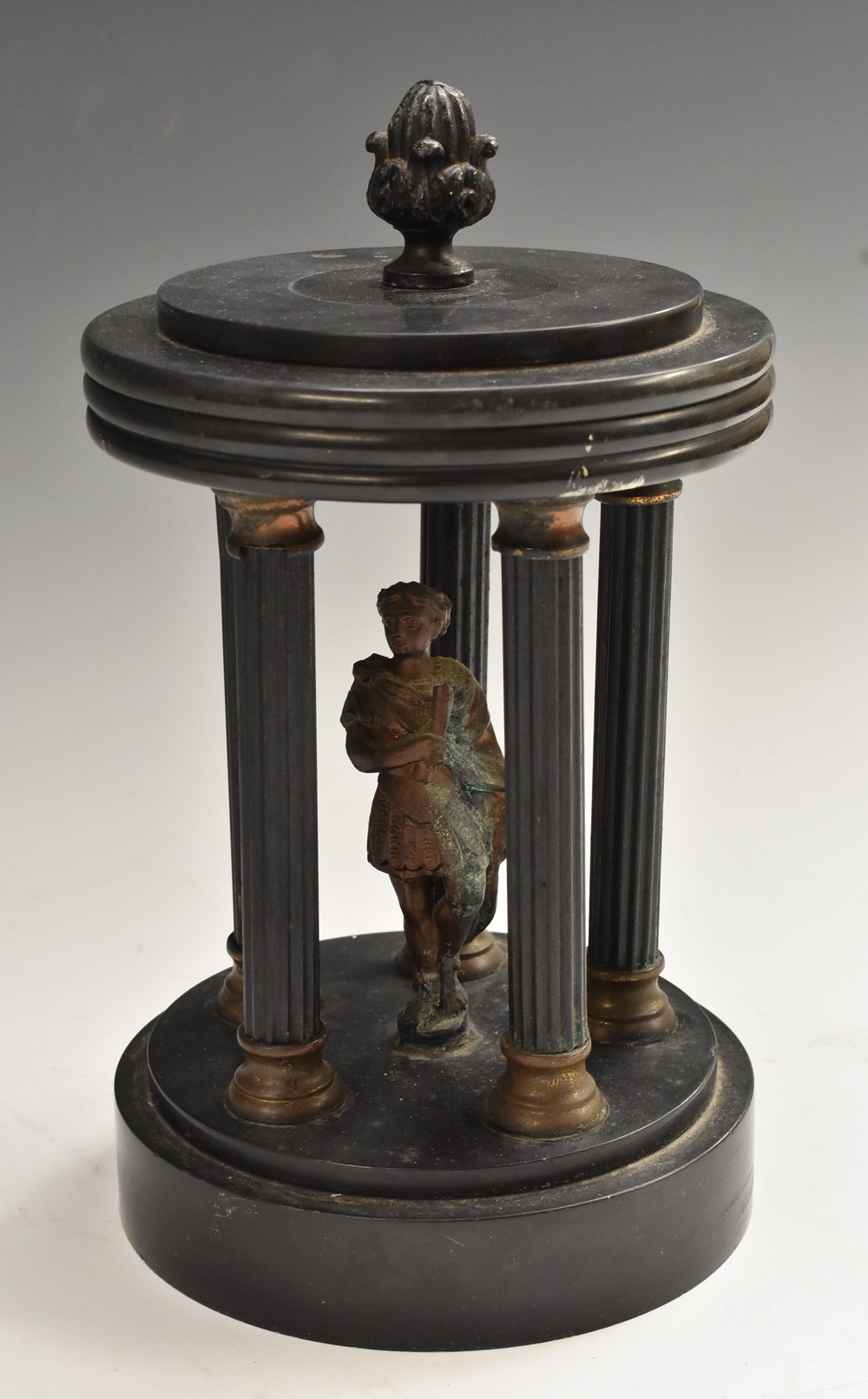 A 19th century Belge noir portico, centred by a figure enclosed by five reeded pillars, 23cm high,