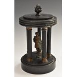 A 19th century Belge noir portico, centred by a figure enclosed by five reeded pillars, 23cm high,