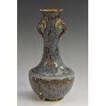 A Chinese Jun ware earthenware bottle vase, glazed in merging mottled tones of blue and purple,