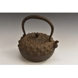 A 19th century Japanese iron tetsubin, hobnail cast, with cover, character marks beneath spout,