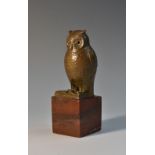 An early 20th century gilt metal novelty desk weight, as an owl perched upon an open book,