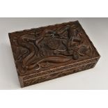 A Burmese hardwood rectangular box, carved in relief with ferocious dragons,