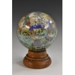 A 19th century novelty decoupage glass globe, the interior of the spheree applied with cartoons,