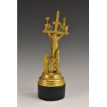 A Continental gilt metal altar devotional, depicting the Arma Christi, ebonised base,