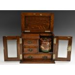 A late Victorian oak gentleman's smoking room cabinet,