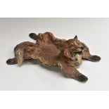 An early 20th century cold painted bronze novelty inkwell, as a fox fur rug,