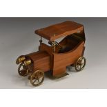 A teak model of a vintage car,