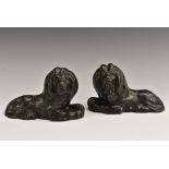 A pair of George III cast iron desk weights or door stops, cast as recumbent lions,