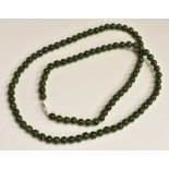 A string of Chinese green jade beads, 39.