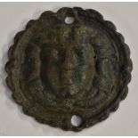 Antiquities - a Medieval verdigris patinated bronze boss, probably a mount from horse furniture,