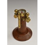 An oak and brass novelty desk model, of a ship's compass, circular base,